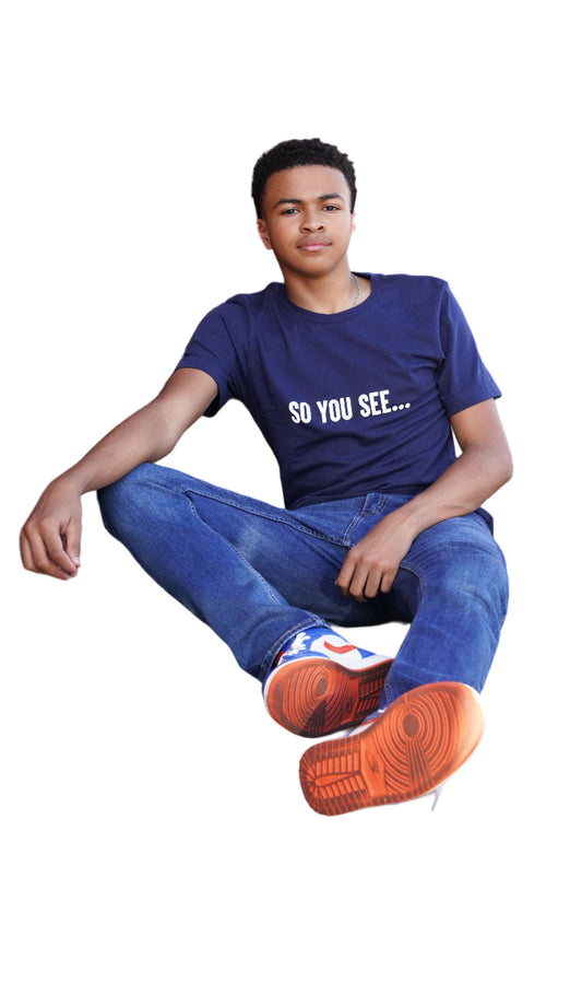 Shaun (Jay) Wears a "So You See..." New Classic Navy Blue Tshirt, sitting down and resting his arm on his knee