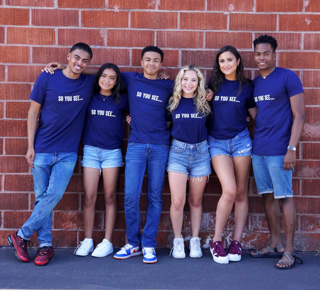 cast members show off the So You See... New Classic T-shirt