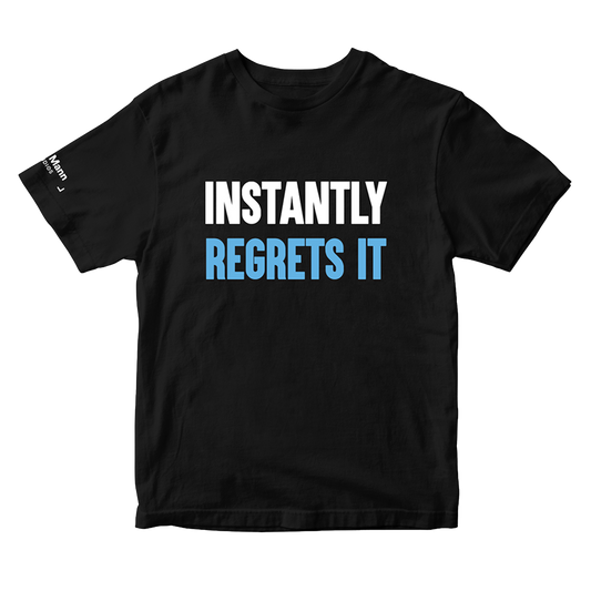 A black short-sleeve t-shirt with the text 'INSTANTLY REGRETS IT'; 'Instantly' is printed in white and 'Regrets it' is printed in light blue. The right sleeve of the t-shirt also has a printed white tag of the "Dhar Mann Studios" logo